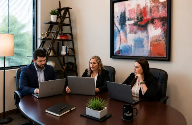 Three Triangle Divorce Lawyers team members working together at a conference table