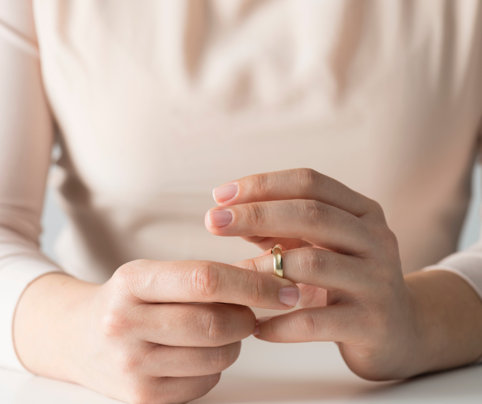woman taking wedding ring off