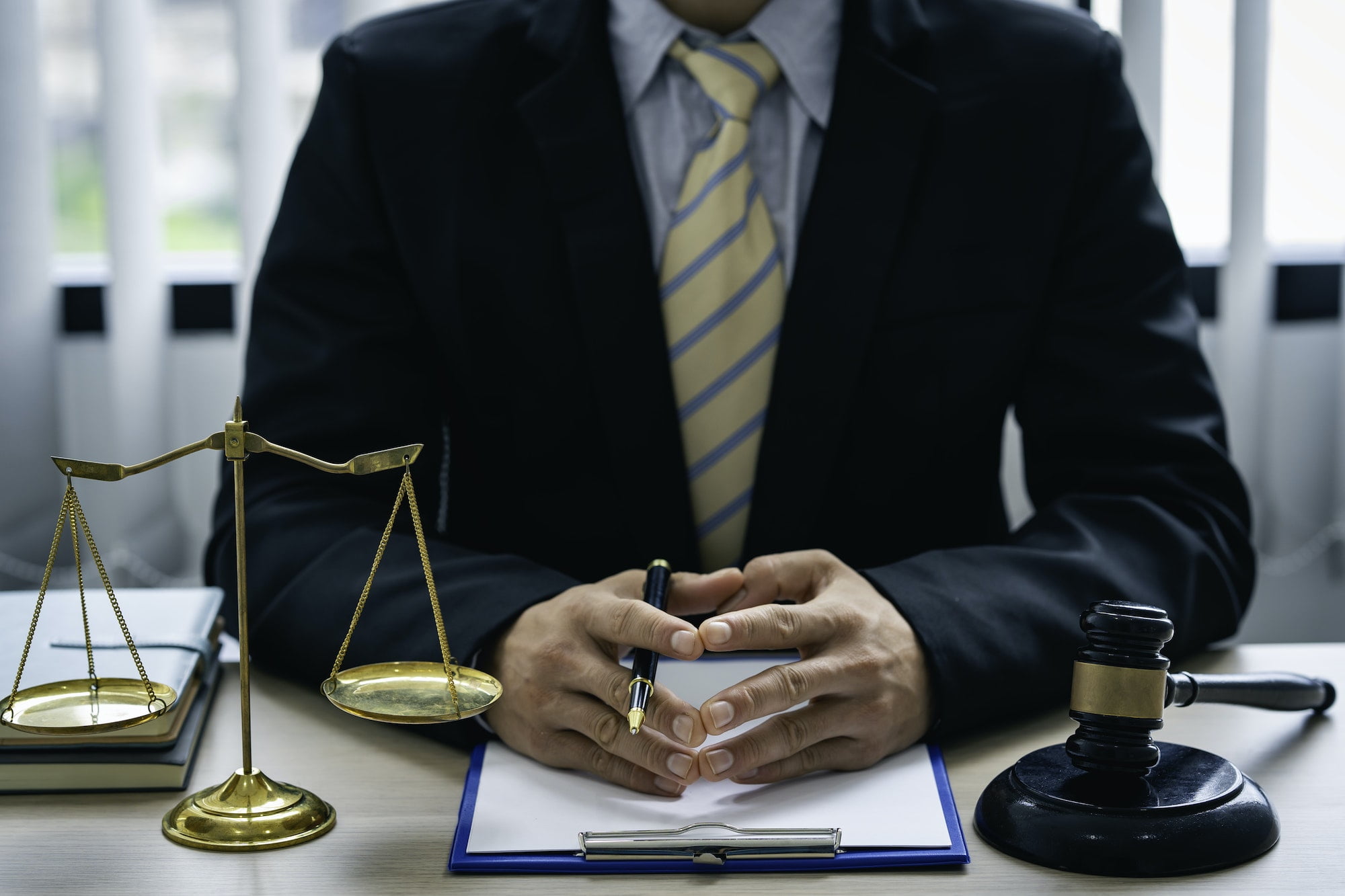 A lawyer or judge is listening to a legal testimony from a client in the lawyer's office. legal advi