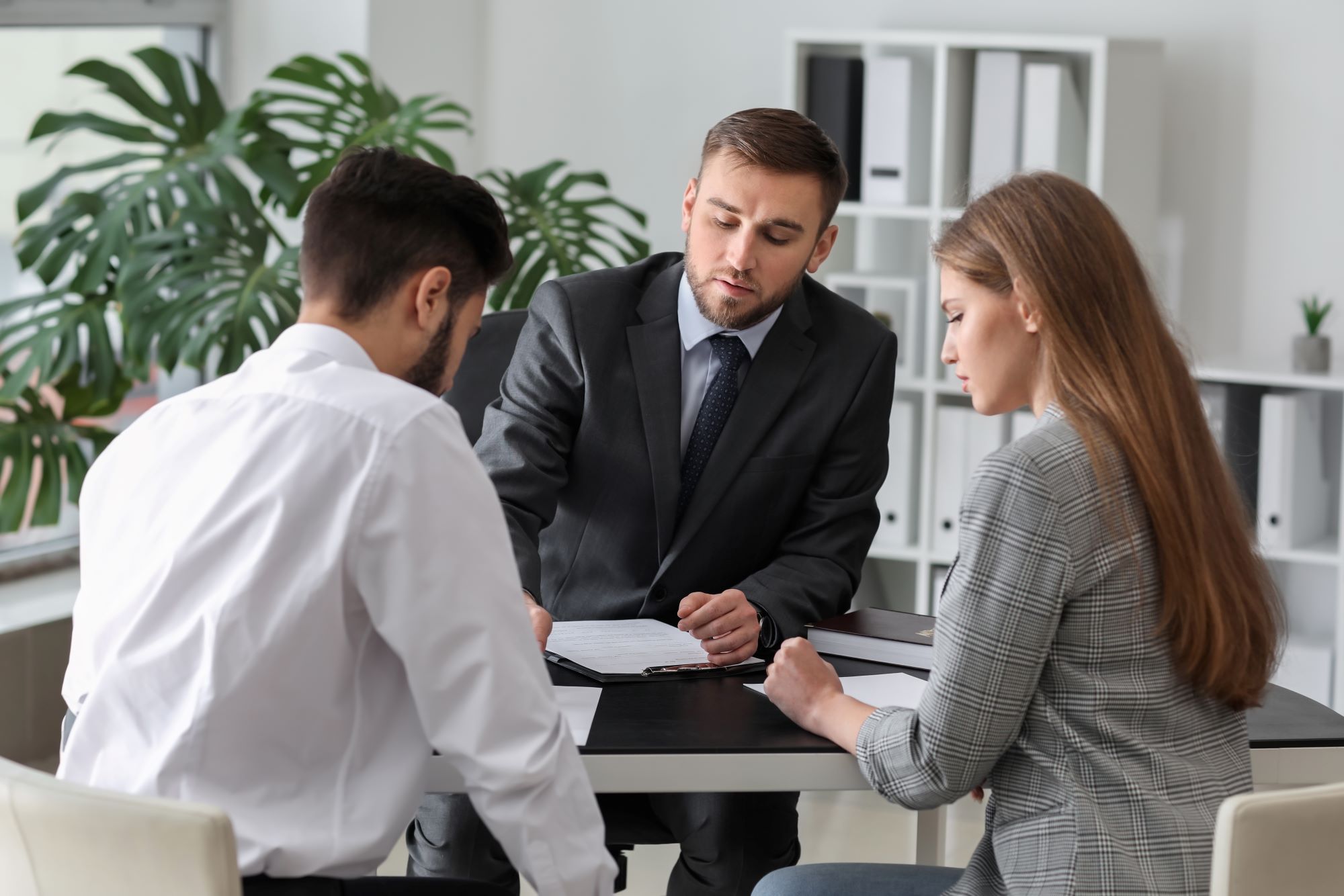 couple reviewing paperwork with attorney