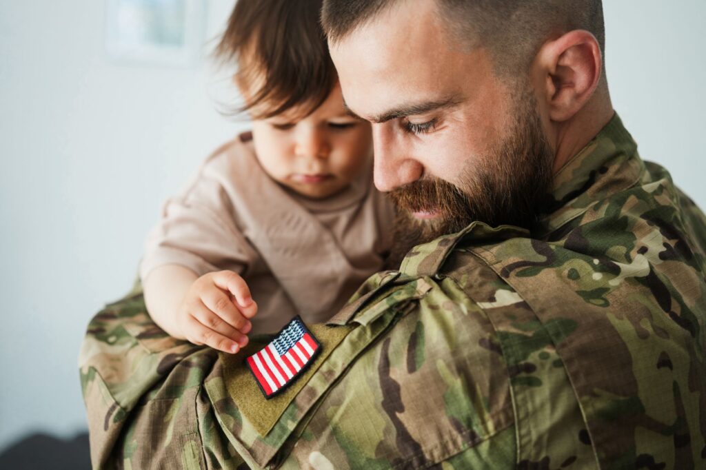 military dad holding child