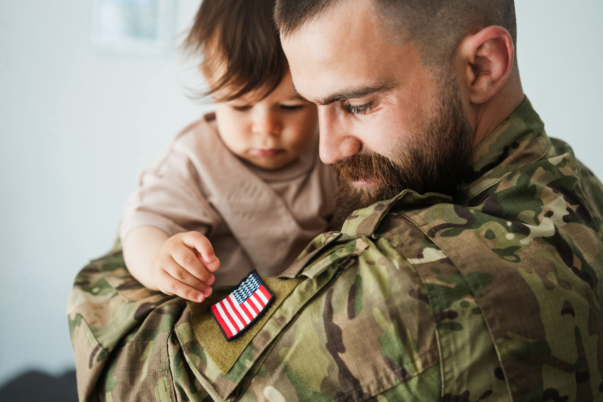 military dad holding child